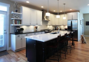 Kitchen - AFTER. Painted existing perimeter cabinets; installed new island cabinetry, countertops, back splash, lighting.